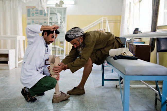 Man learning about his prosthetic leg from a medical professional section image